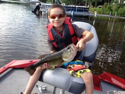 Angler holding a largemouth bass in NH