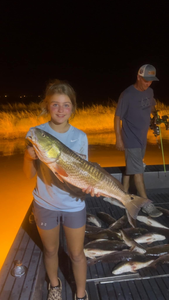 Two people fishing in LA with one 23-inch catch
