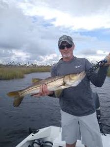 Fisherman holding a 26-inch catch in Florida