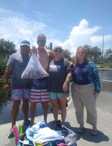 4 people fishing with 1 fish in Brooksville