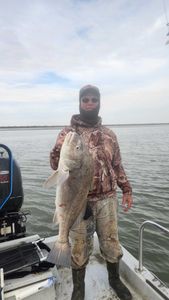 A fisherman casting a line in Aransas Pass