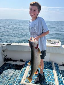 Successful fisherman holding a 22-inch fish in Altmar
