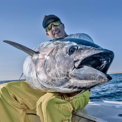 A person fishing in Hingham with a 30-inch fish