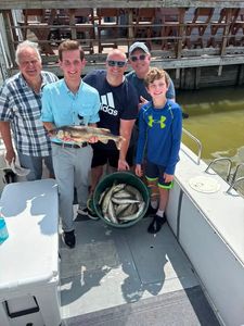 Fishing group displays caught fish on boat deck at Port Clinton OH with bucket of additional catch