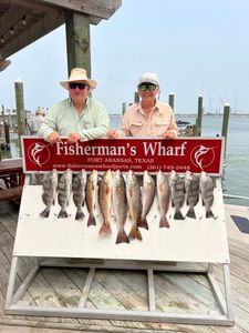 Fishing charter display showing redfish and black drum catch at Fisherman's Wharf in Rockport TX