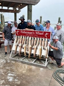 Successful redfish fishing trip at Fisherman's Wharf in Rockport TX with multiple redfish displayed on cleaning station