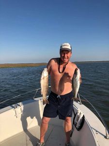 Two small fish caught on a fishing trip in FL