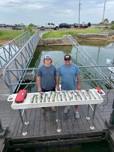 Two people fishing in Madill