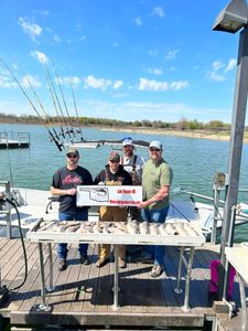 Smiling group of four people fishing in OK