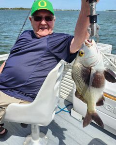 A lone fisherman reeling in a catch in FL