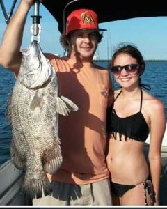 Two anglers with a large 27-inch fish on a fishing tour in Jensen Beach