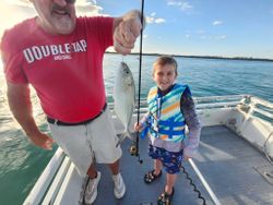 Two people fishing for blue runner fish in Florida