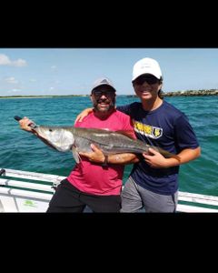 Anglers catching a big fish during a fishing tour in Jensen Beach