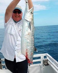Angler holding a 27-inch fish during a fishing tour in Jensen Beach