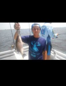 A fisherman reeling in a 13-inch catch at Jensen Beach