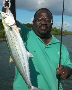 A fisherman holding a Spanish mackerel caught in FL