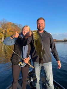Two anglers fishing at Lake Elmo, with one fish caught.