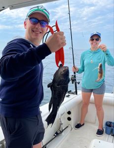Angler with a sea bass, fishing in NJ