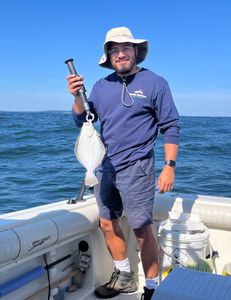 Fisherman holding a freshly caught fish in NJ