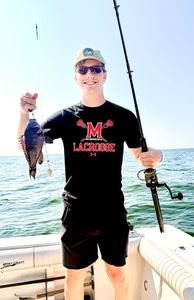 A fisherman catching a sea bass on Port Monmouth Road