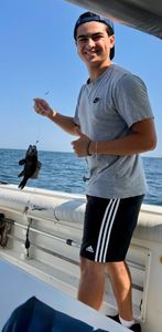 A fisherman catching a sea bass in New Jersey