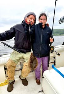 Two anglers fishing in New Jersey with a small 13-inch fish