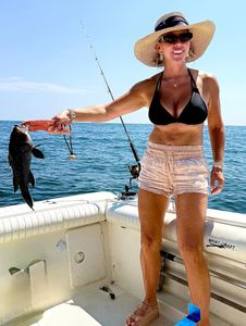 A person fishing for a sea bass in New Jersey