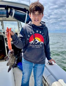 A photo of a 9-inch sea bass caught while fishing on Port Monmouth Road.