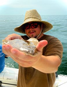 One fisherman reeling in a catch on Port Monmouth Road