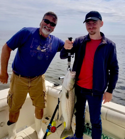 Striped bass fishing success on boat in Port Monmouth Road NJ waters