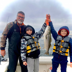 Striped bass fishing success on boat in Port Monmouth Road NJ waters