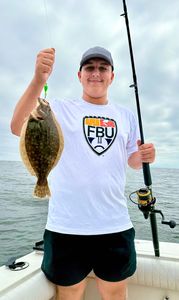 Fisherman with a summer flounder fish on Port Monmouth Road