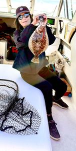 Angler holding a summer flounder on Port Monmouth Road