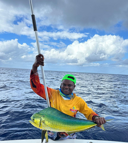 A fisherman holding a large Mahi Mahi or Common Dolphinfish in Puerto Plata
