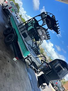 Large fishing boat with outriggers docked at marina in Punta Gorda FL