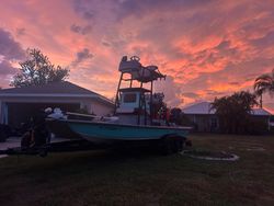 Fishing boat on trailer parked in residential yard in Punta Gorda FL during colorful sunset