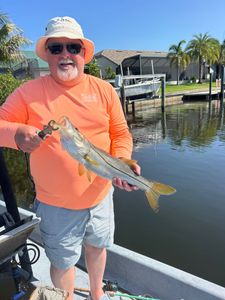 Angler holding freshly caught snook on boat in Punta Gorda FL waterway