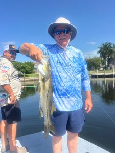 Angler holding caught snook fish on fishing boat in Punta Gorda FL waters