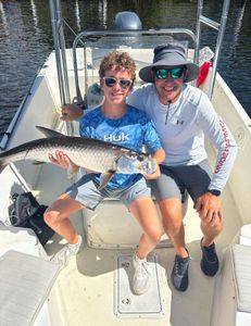 Three people fishing for a tarpon in Punta Gorda
