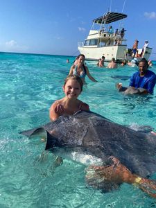 Joyful Stingray City moment in crystal-clear water