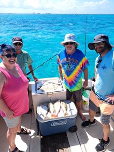 Colorful crew with a fresh reef fish haul!