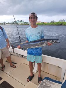 Proud Wahoo catch on a cloudy Cayman day!