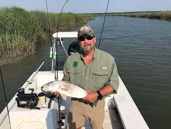 Angler with a 13-inch redfish in South Carolina