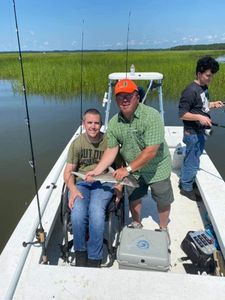 Trio of anglers proudly displaying their catch on the South Carolina coast