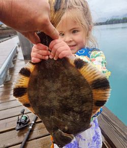 Fisherman reeling in a 14-inch catch in Seward