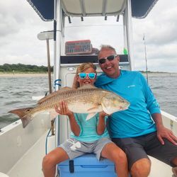 Fisherman catching a redfish in SC
