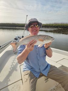 Angler holding a large redfish caught in SC