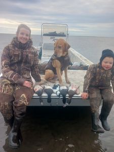Three people enjoying fishing and hunting adventure in Manteo