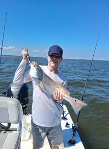 A person fishing in Manteo