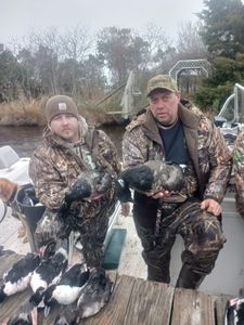 Two people fishing in Manteo